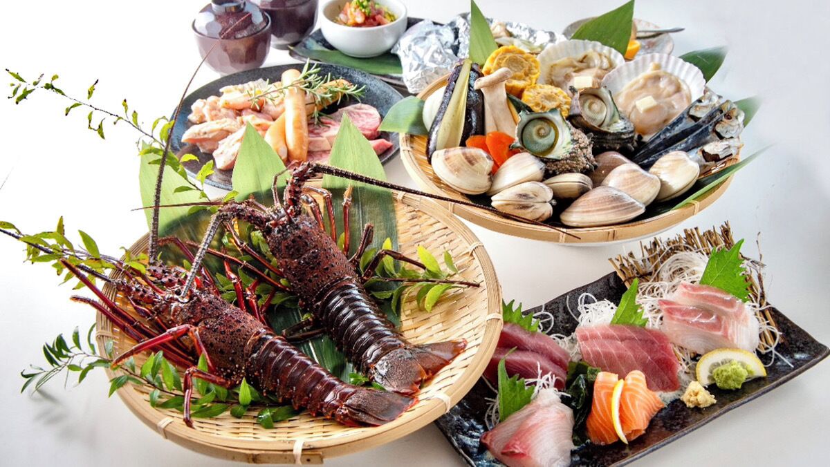 A variety of seafood dishes including lobster, clams, and sushi, arranged on plates and in a basket.