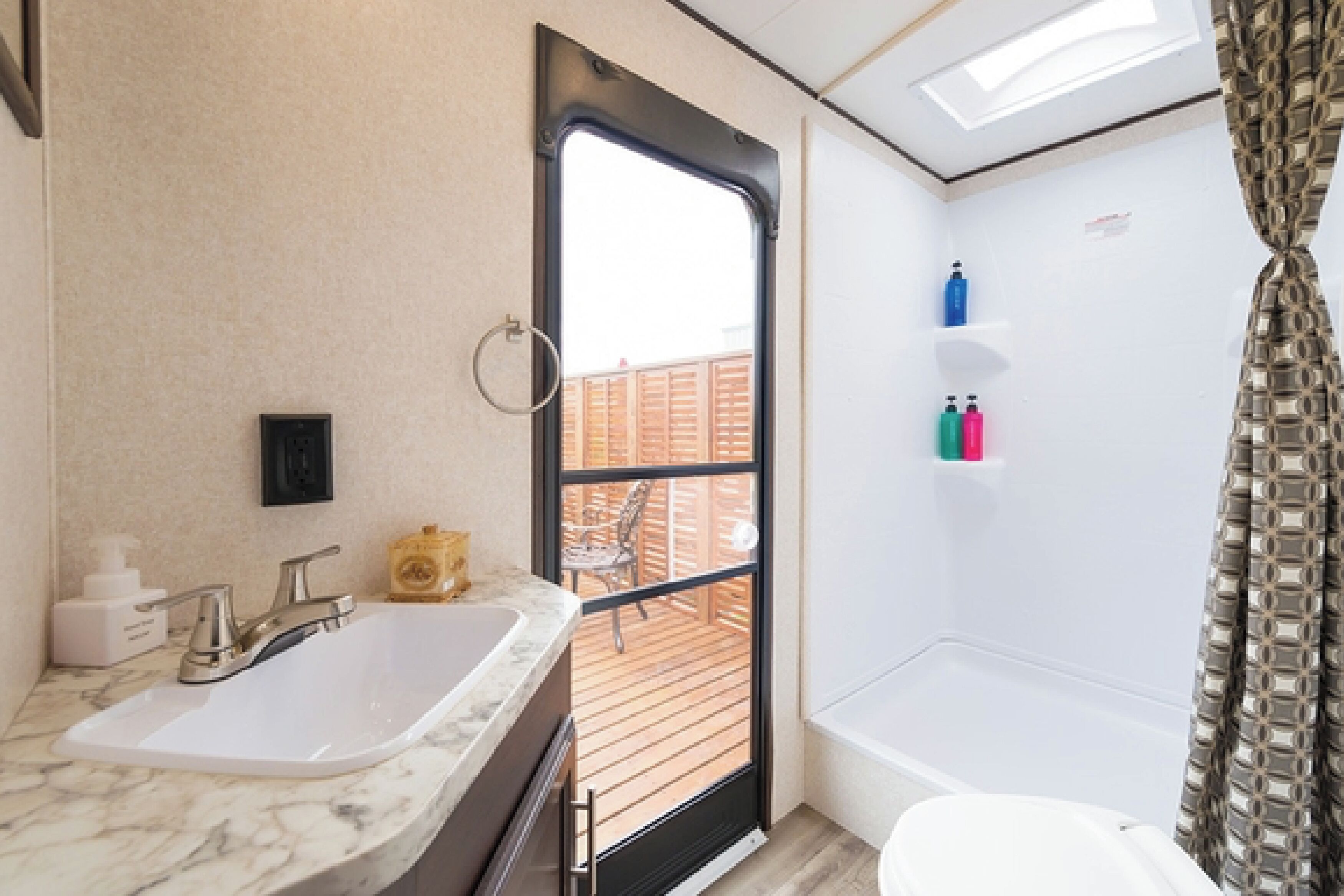 A bathroom with a sink, toilet, and shower.