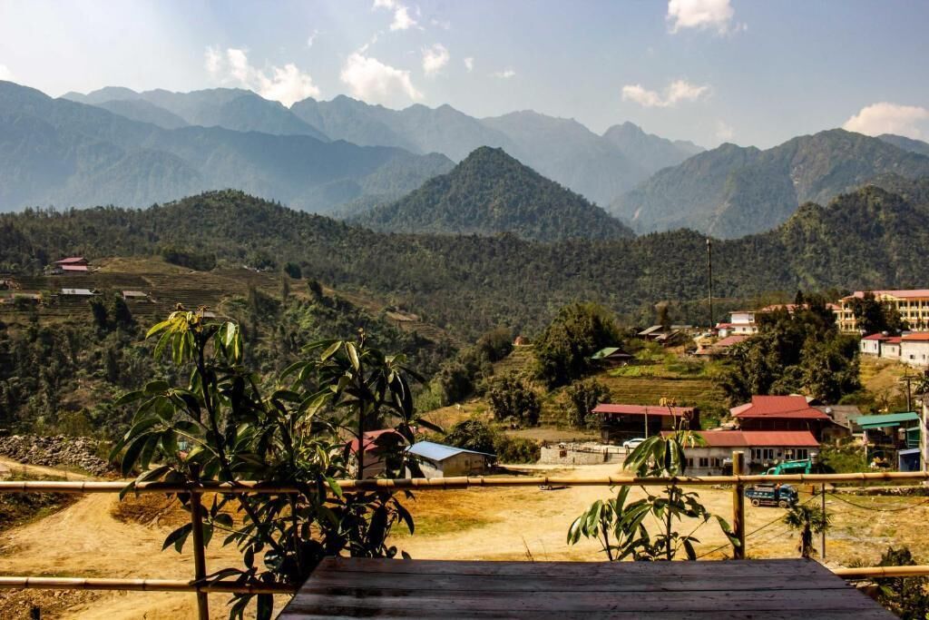 A mountainous landscape with terraced fields and scattered buildings.