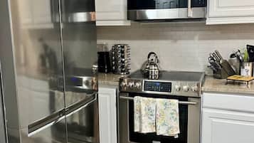 Fridge, coffee/tea maker, cookware/dishes/utensils