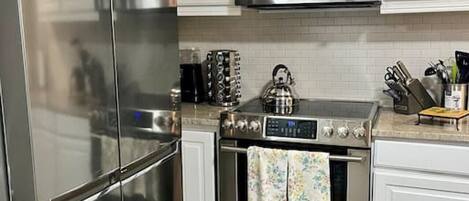 Fridge, coffee/tea maker, cookware/dishes/utensils