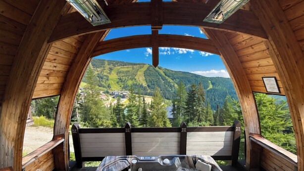 A wooden cabin with a hot tub and a scenic mountain view. - Ski-In/Ski-Out Schweitzer Chalet + Private Hot Tub - Guest Favorite (Sandpoint)