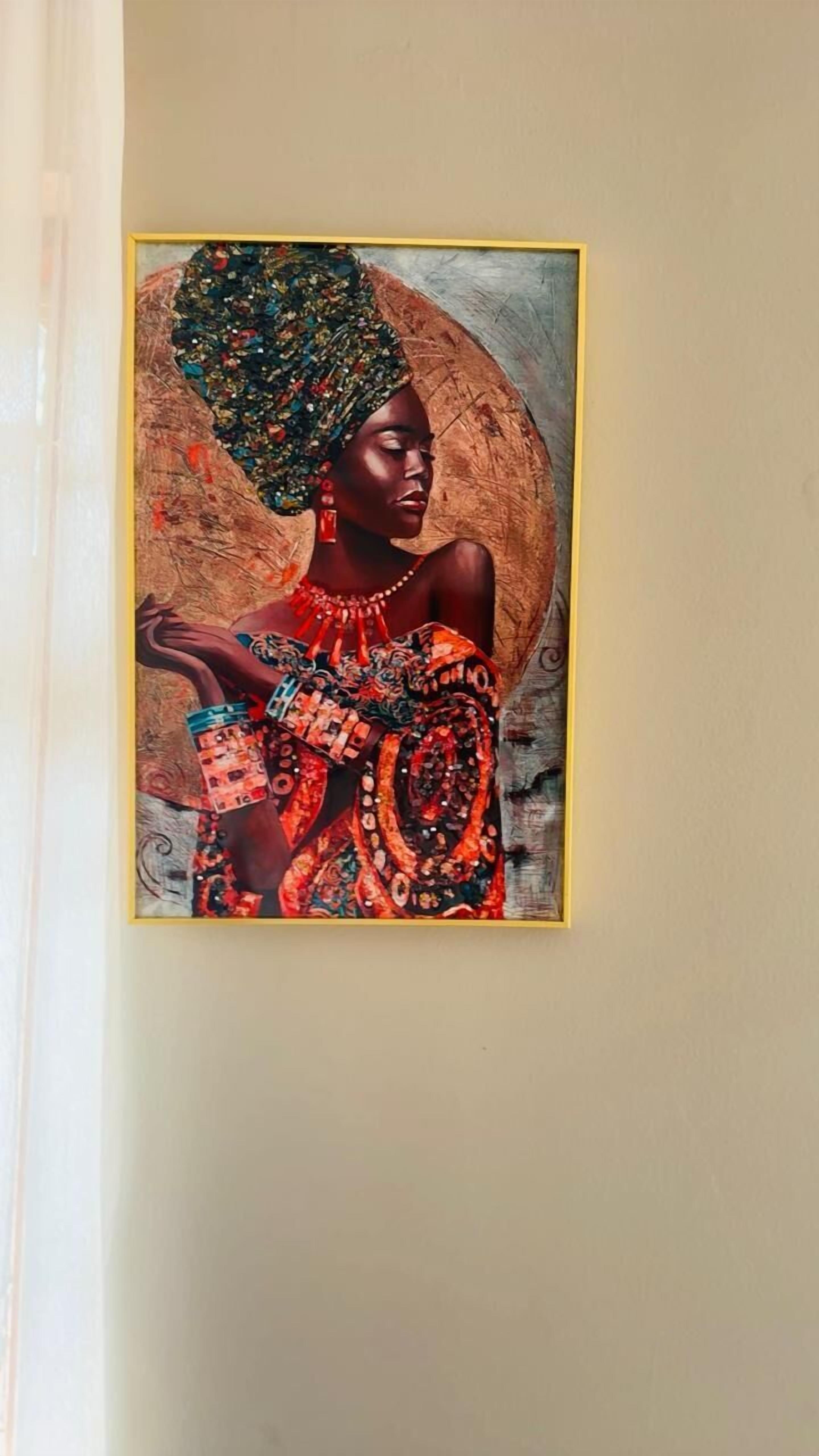 A framed artwork of a person in traditional attire on a wall.