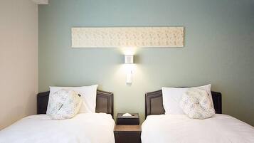 A hotel room with two beds, a nightstand, a wall-mounted light, and a decorative panel above the beds.
