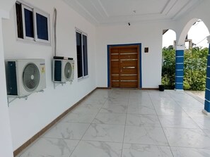 Enter a clean, well-maintained space with a tiled floor and air conditioning units.
