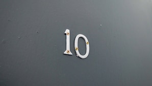 A metal number '10' on a dark surface. - Lovely 2-bed Studio10 in Coventry (Coventry)