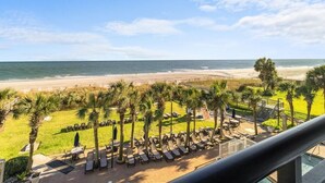 A beach view with lounge chairs and palm trees. - Majestic Oceanfront Ste with Hot Breakfast 3rd Flr (Myrtle Beach)