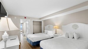 A hotel room with two beds, a desk, a lamp, and a wardrobe. - Majestic Oceanfront Ste 4th Flr Include Breakfast (Myrtle Beach)