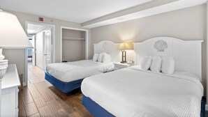 A hotel room with two beds, a desk, and a lamp. - Roomy Oceanfront Ste with Free Breakfast 4th Flr (Myrtle Beach)