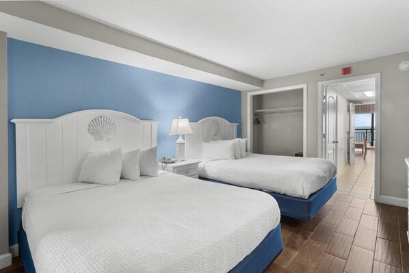 A hotel room with two beds, a walk-in closet, and a view of the balcony. - Spacious Oceanfront Suite: 5th Flr W Breakfast (Myrtle Beach)