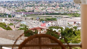 A cityscape with a view of a busy road, buildings, and greenery.