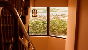 A staircase leading to a balcony with a view of a landscape.