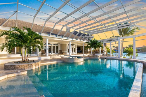 Waterfront home on Marco Island, large pool, & dock. Sleeps 18, many amenities.
