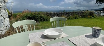 Old Thatch Cottage in the Burren views over Galway Bay on the Wild Atlantic Way