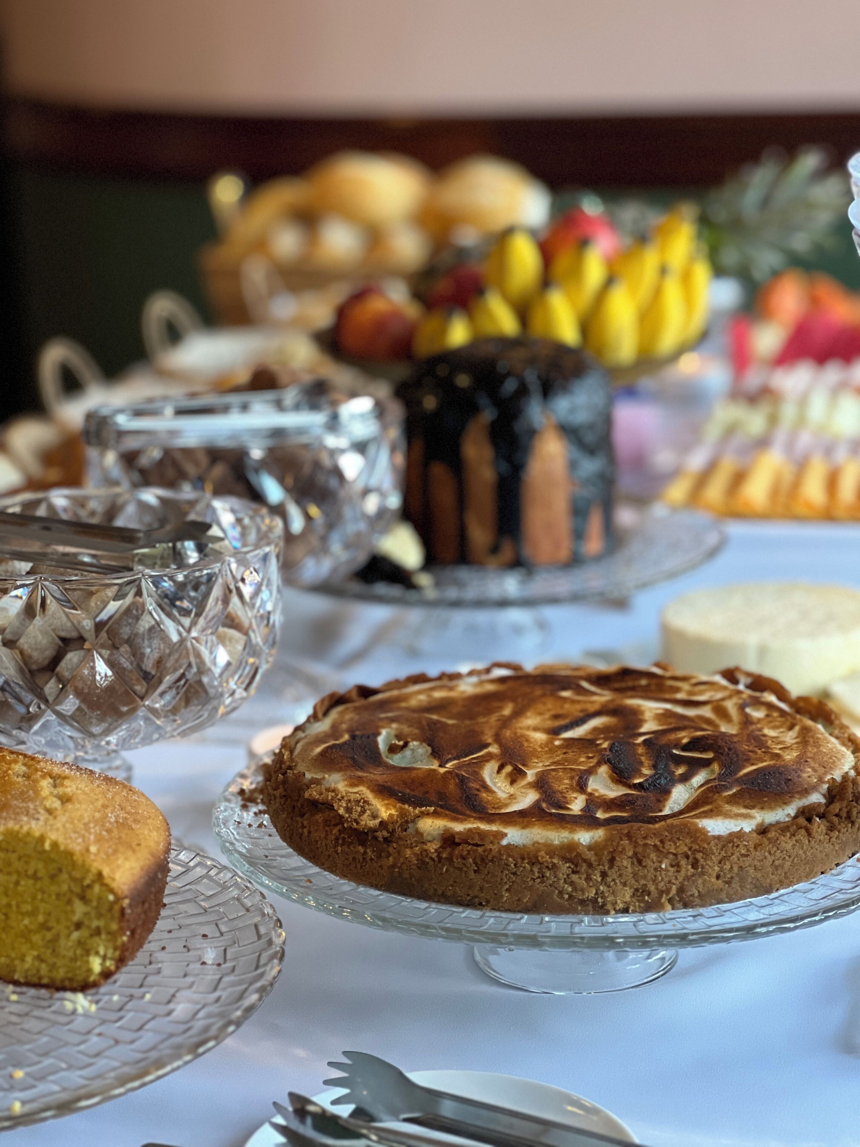 A table with various desserts and fruits.
