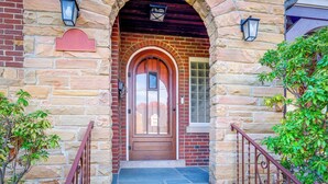 A stone building with a wooden door, a red mailbox, and a small window with a grid pattern. - Silver Springs Home: Walk to Downtown! (Silver Spring)