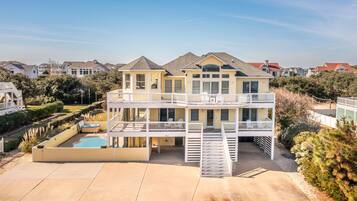 Enjoy a relaxing stay in this two-story house with a spacious backyard, covered patio, and swimming pool.