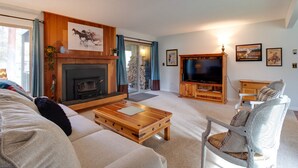 A living room with a fireplace, a television, and a sofa.