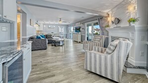 A spacious living room with a fireplace, a dining area, and a kitchen. - Waterfront w/dock & hot tub, bring your boat/jet ski-5 minutes from beach-LBI!!! (Manahawkin)
