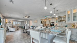 A spacious kitchen with a large island, white cabinetry, and pendant lighting. - Waterfront w/dock & hot tub, bring your boat/jet ski-5 minutes from beach-LBI!!! (Manahawkin)