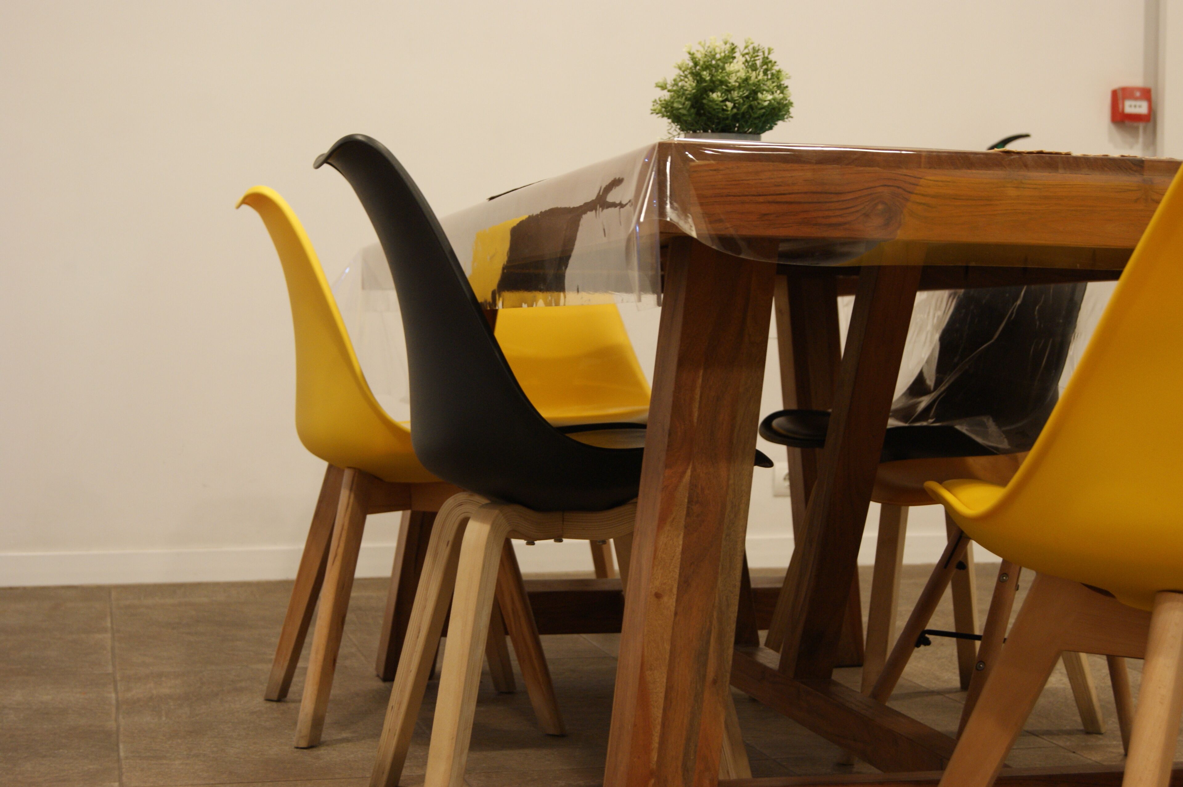 A dining area with a wooden table and yellow chairs.