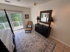 A room with a large window, a chair, a dresser, and a patterned rug. - Stella Maris • Walk to Cruz Bay • Pool • Generator Backup • Car Rental Available (Cruz Bay)