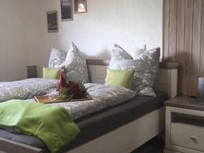 Cozy retreat with a double bed, bedside table, and framed artwork.