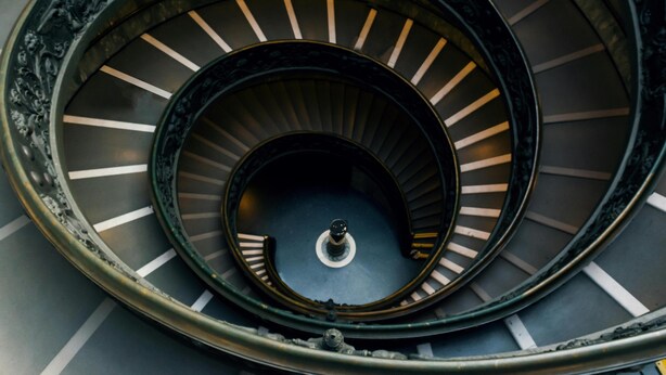 A spiral staircase with ornate metal railings and a central column. - Vatican Green Garden (Rome)