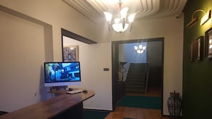 A room with a wooden desk, a computer monitor, and a staircase leading to another area. - VILLA ADAM (Tangier)