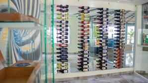 A wine cellar with rows of wine bottles on glass shelves. - El Paso Hotel (Laguna Salada)