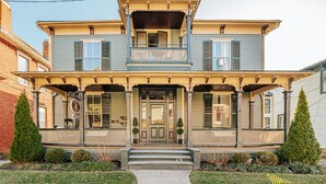 A two-story house with a front porch, a balcony, and a front door. - The Bons Amis Suite: Chic Decor, Walk Downtown (Staunton)