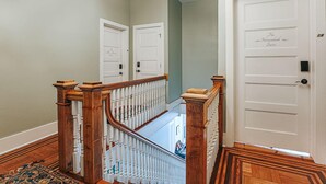 A staircase with wooden balusters and a white handrail leading to a door labeled 'The Sherndale Suite.' - The Bons Amis Suite: Chic Decor, Walk Downtown (Staunton)