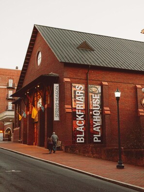 A brick building with a sign reading "BLACKFRIARS PLAYHOUSE" and "SPRING SEASON".