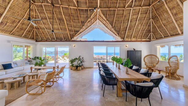 A spacious room with a high ceiling, large windows, and a view of the sea. - The Sweet Life Sayulita | Ocean Views (Sayulita)