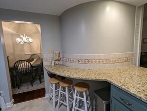 Enjoy meals in this kitchen with a bar area and adjacent dining space.