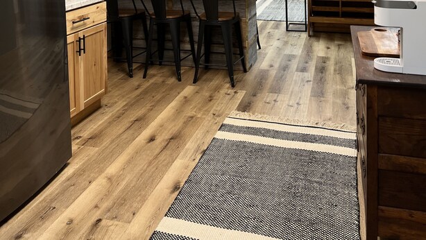 A modern kitchen with a central island, wooden cabinets, and a black refrigerator. - LakeWay II- 4 min from US-41 and Lake Sullivan (Sullivan)
