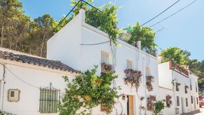 A white building with multiple windows, some with shutters, and a tiled roof. - 2 bedroom luxurious home in El Gastor (El Gastor)