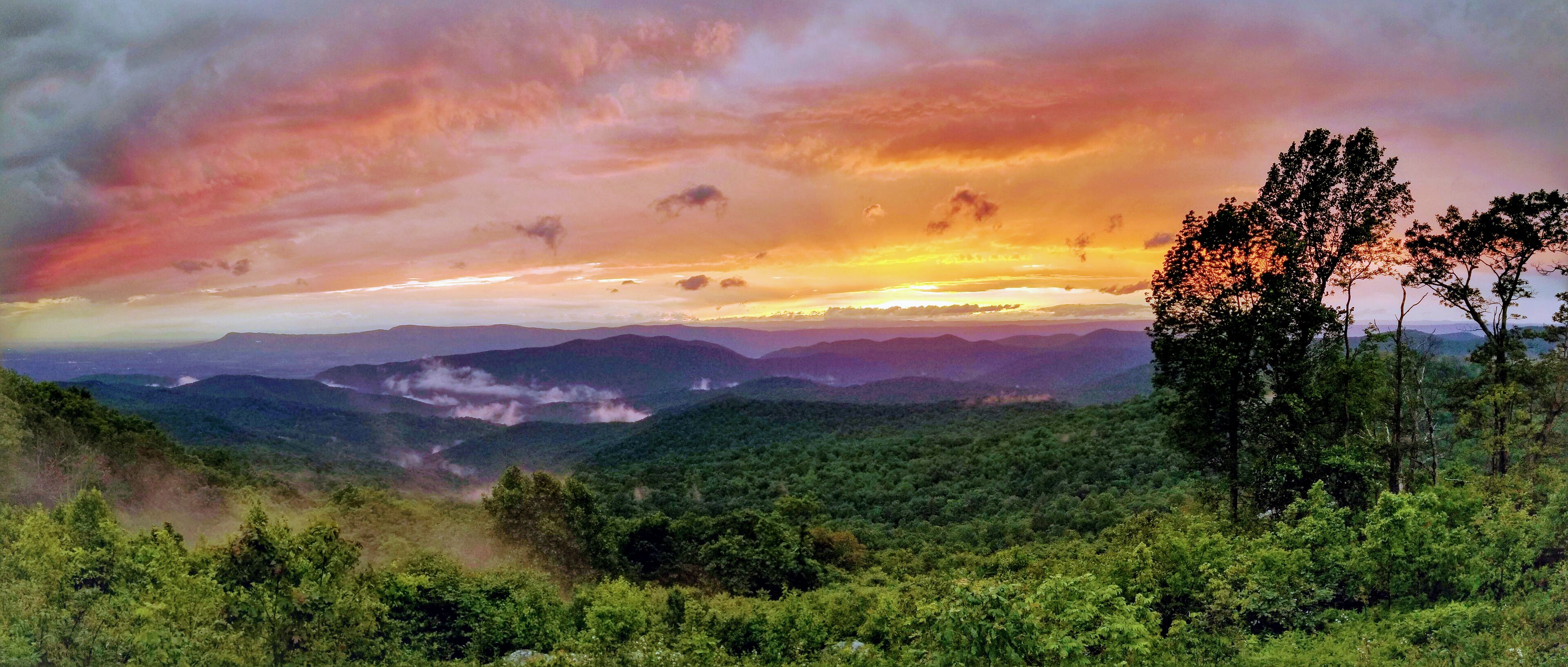 A mountainous landscape with a sunset.