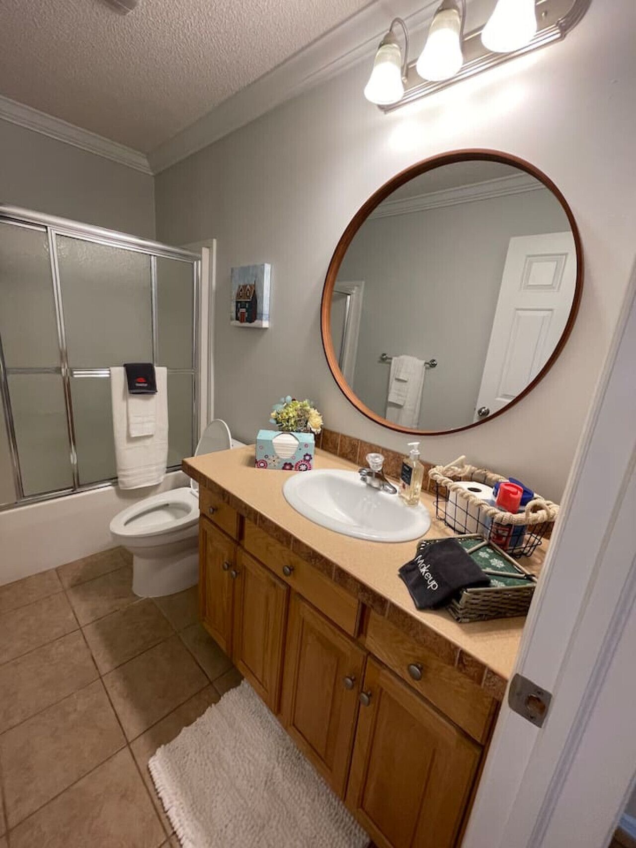 A bathroom with a toilet, sink, and shower.
