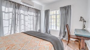 A bedroom with a bed, a desk, and a chair. - 1926 Original Firehouse / Close to U of A / Loft (Tucson)
