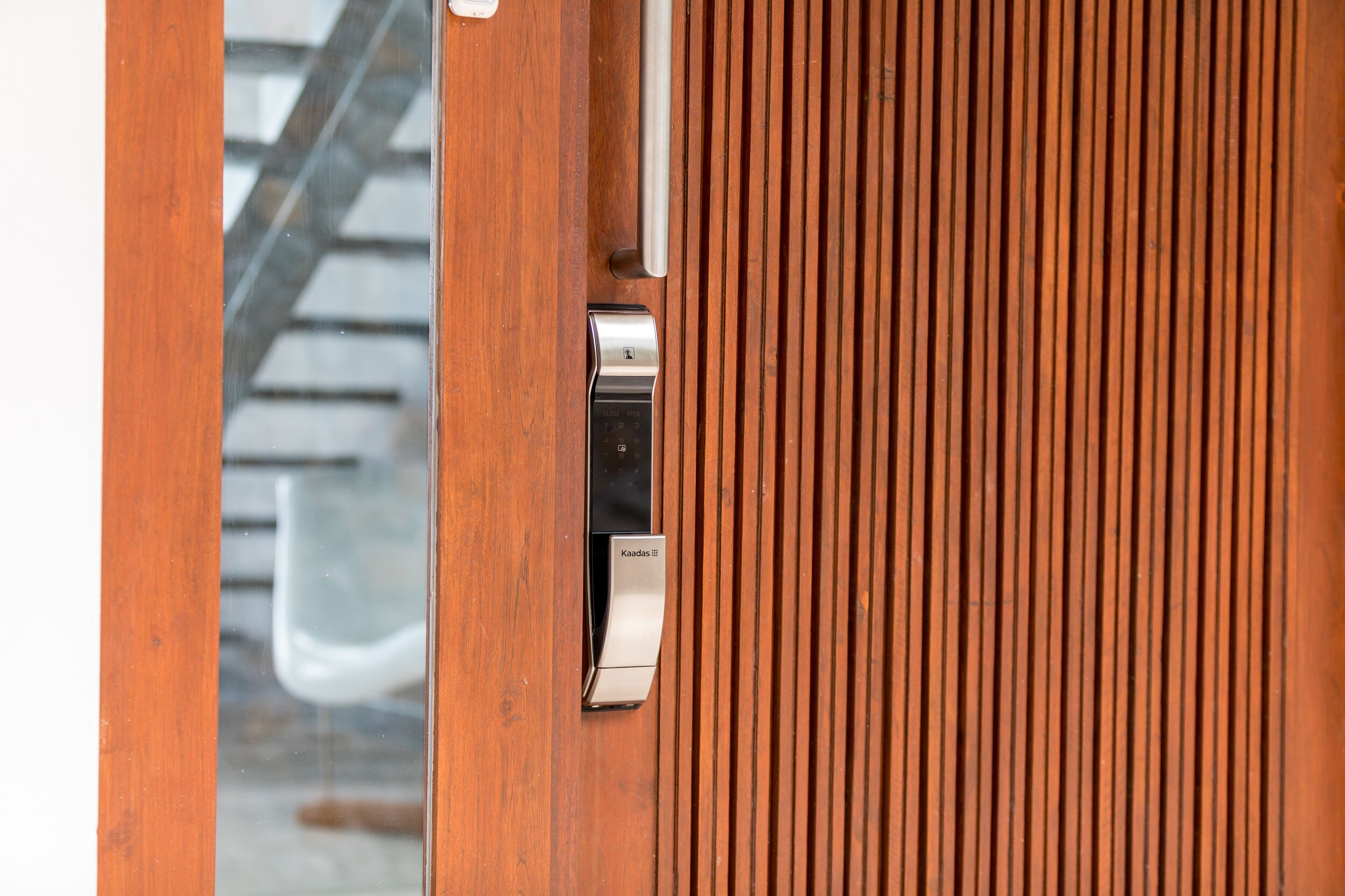 A wooden door with a modern, metallic handle and a keycard slot.