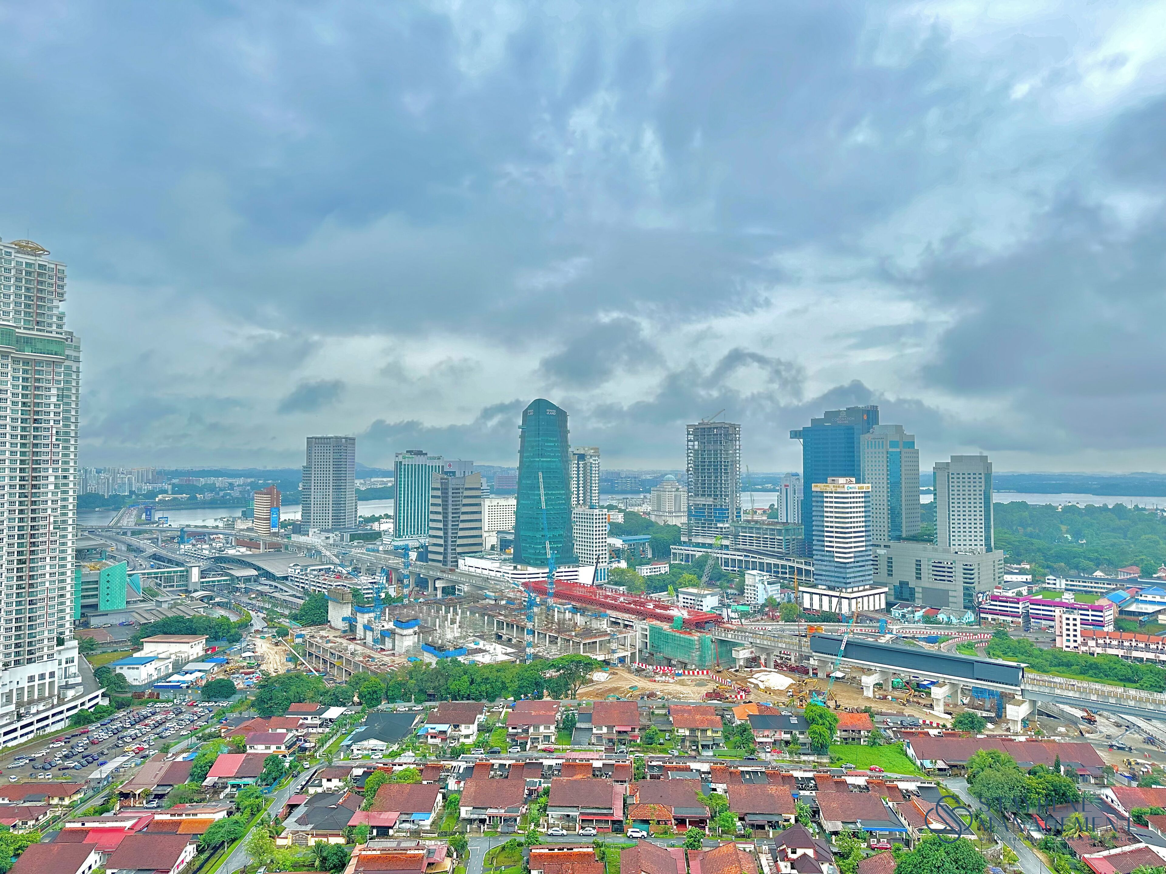 A cityscape with high-rise buildings, a bridge, and a mix of residential and commercial areas.