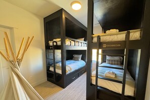 A bunk bed room with a sign reading "Thatcher's Turn".