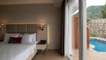 A bedroom with a bed, bedside table, and a view of a swimming pool.
