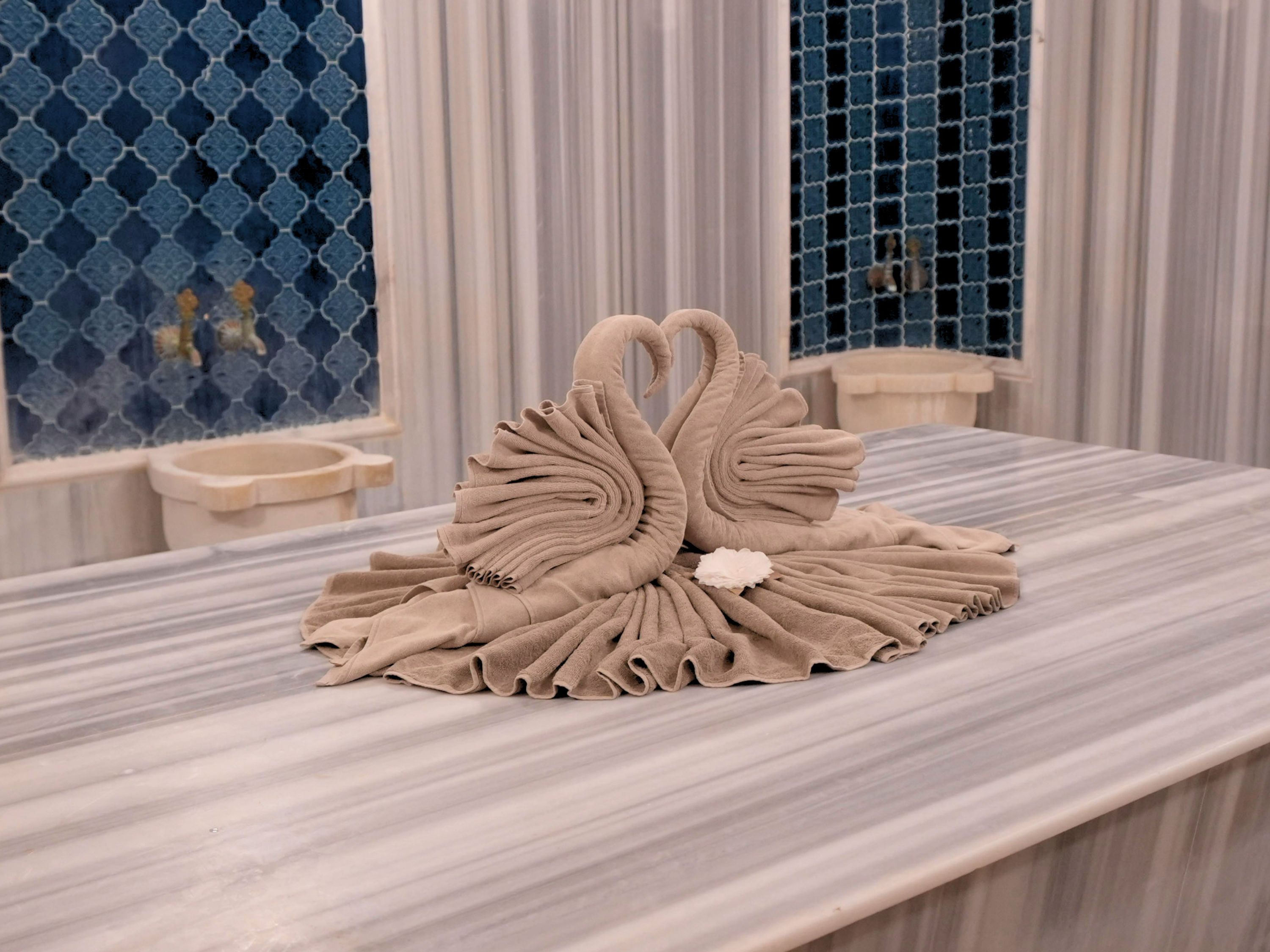 A marble table with a decorative swan centerpiece.