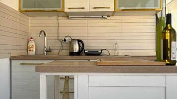 Family Apartment | Private kitchen | Fridge, stovetop, cookware/dishes/utensils, dining tables