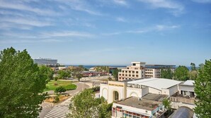 A view of Delmar Ballrooms with a clear sky and greenery around. - Hotel Alma (Constanta)