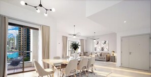 A modern living room with a dining area, large windows, and a view of a cityscape.