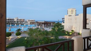 Et resort med pool, udendørs siddepladser og havudsigt.