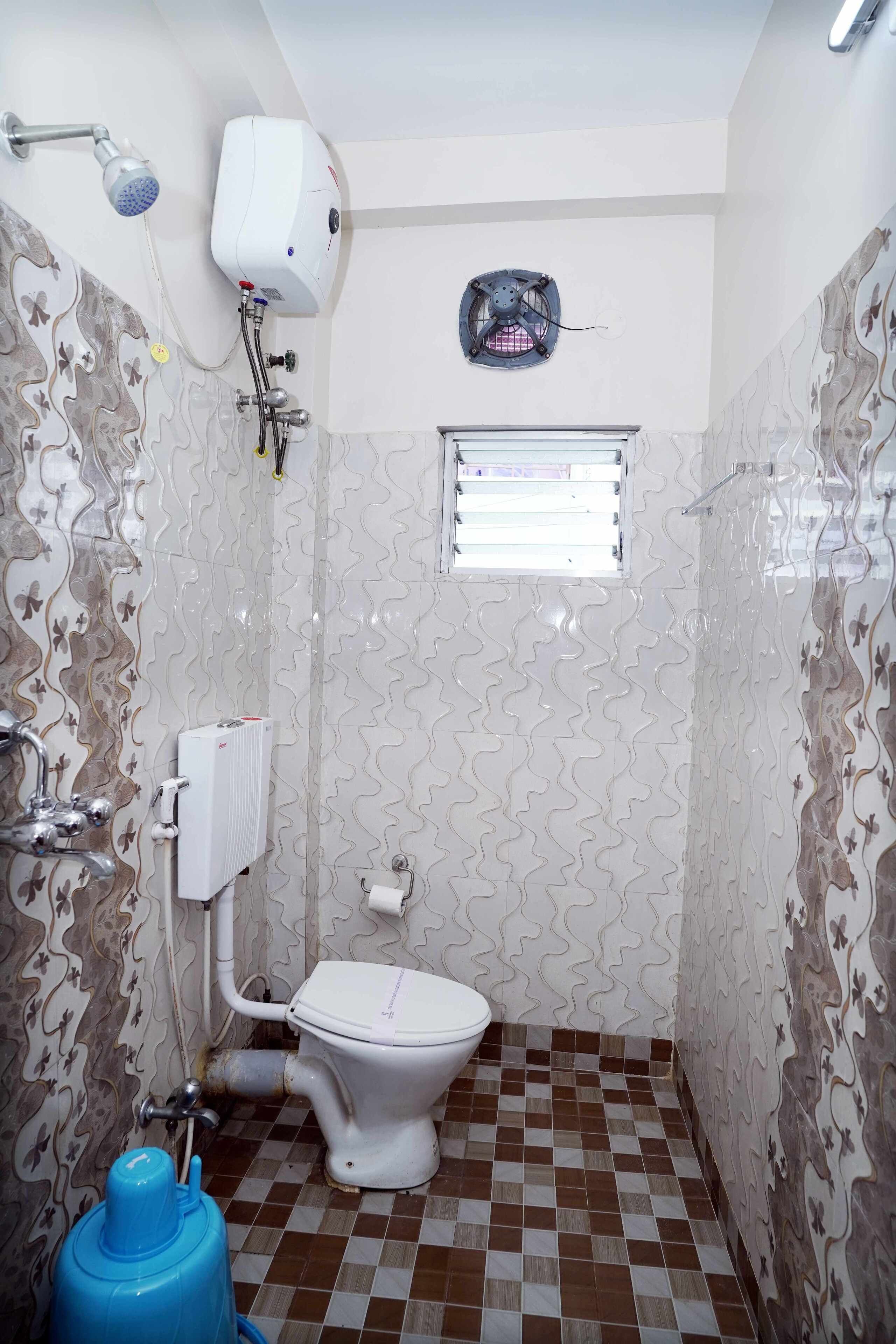 A bathroom with a toilet, shower, and a radiator.